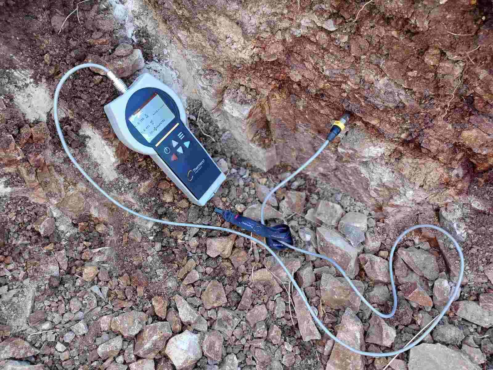 Digital geotechnical testing instrument with sensor probes on rocky soil